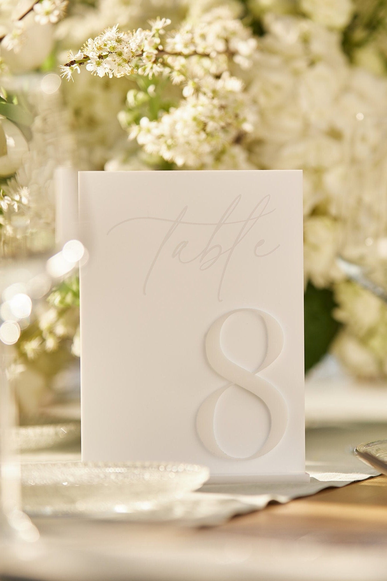 Elegant matte white table number for wedding reception
