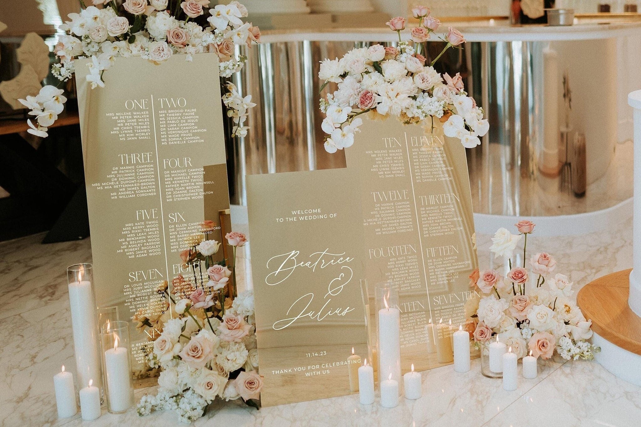 Gold mirror seating chart sign with guest list display
