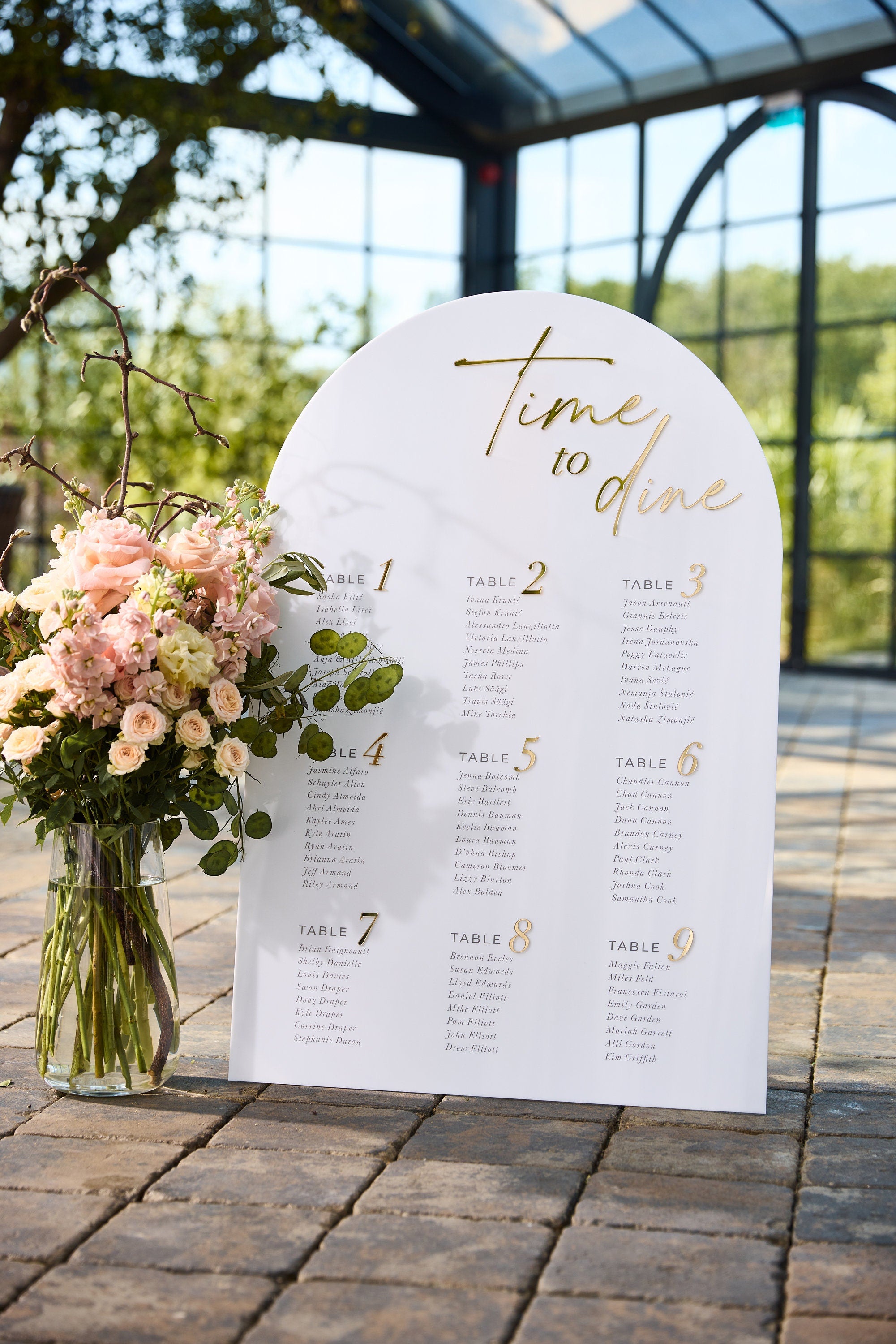 Arched seating plan with Time to Dine header in 3D gold mirror showing guest names and table numbers
