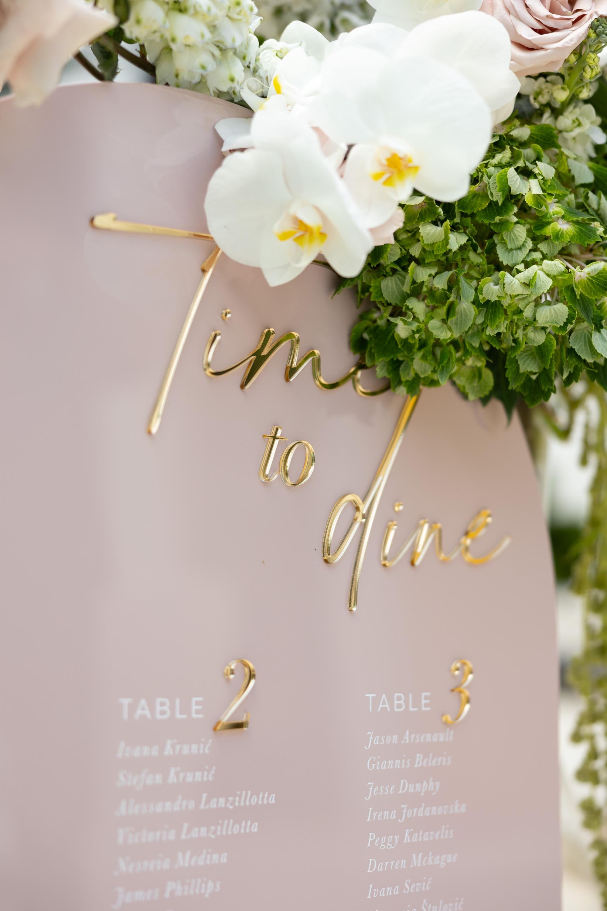 Elegant pink seating plan with raised gold mirror lettering
