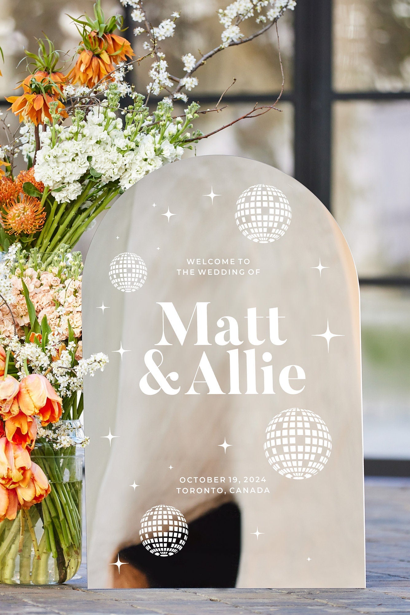 Arched silver mirror welcome sign with disco ball and custom text
