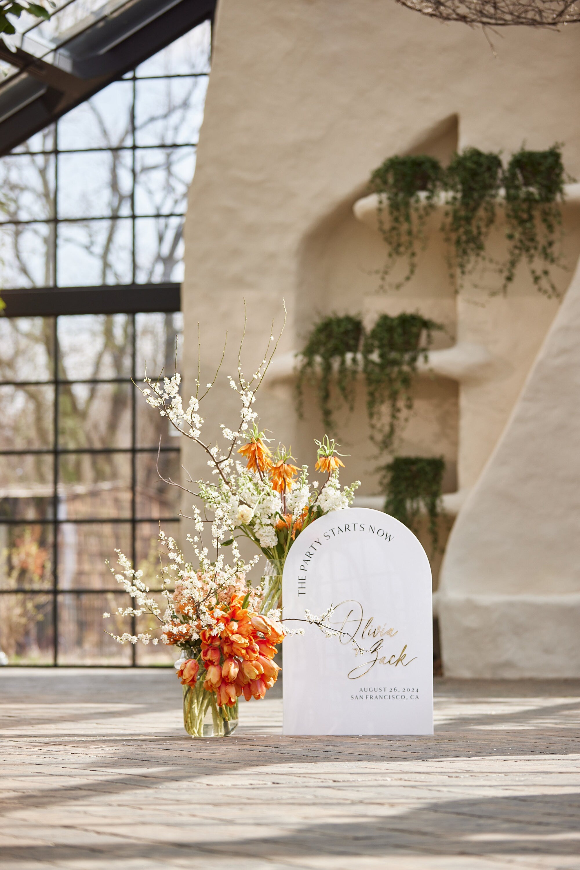 Arched white acrylic welcome sign for wedding reception entrance decor
