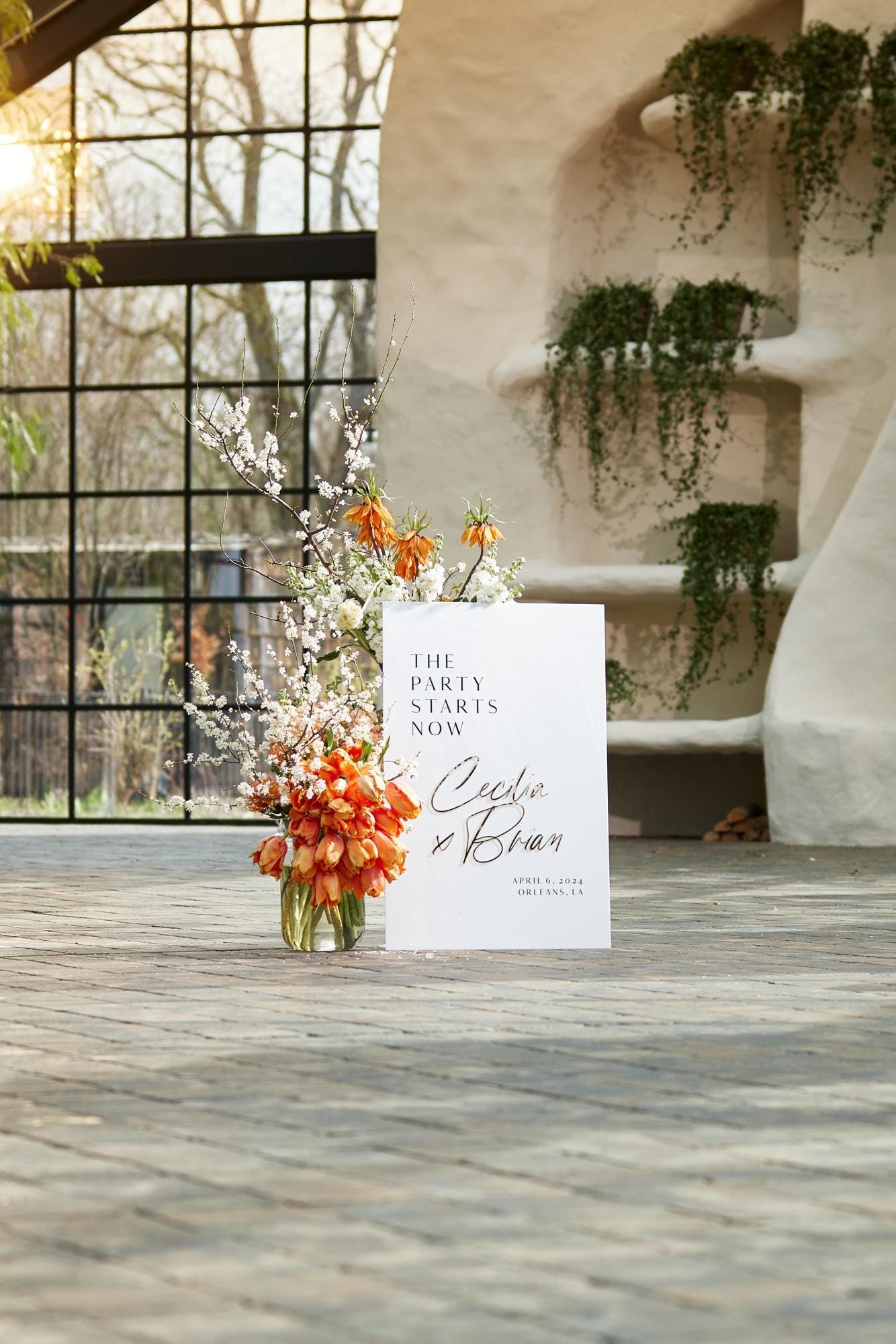White and gold wedding sign with 3D mirror names displayed at ceremony entrance
