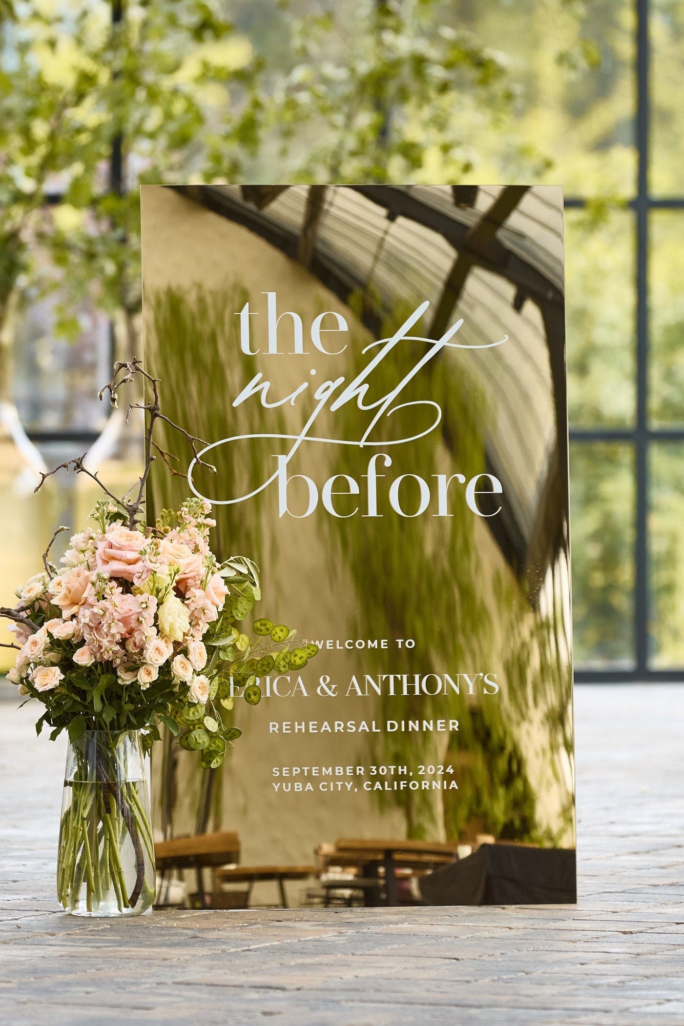 Gold mirror rehearsal dinner welcome sign with The Night Before text and personalized names
