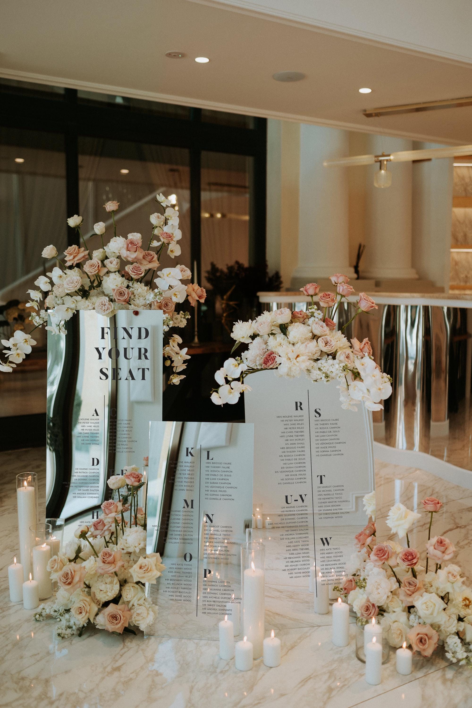 Custom acrylic seating chart in silver mirror finish with guest names
