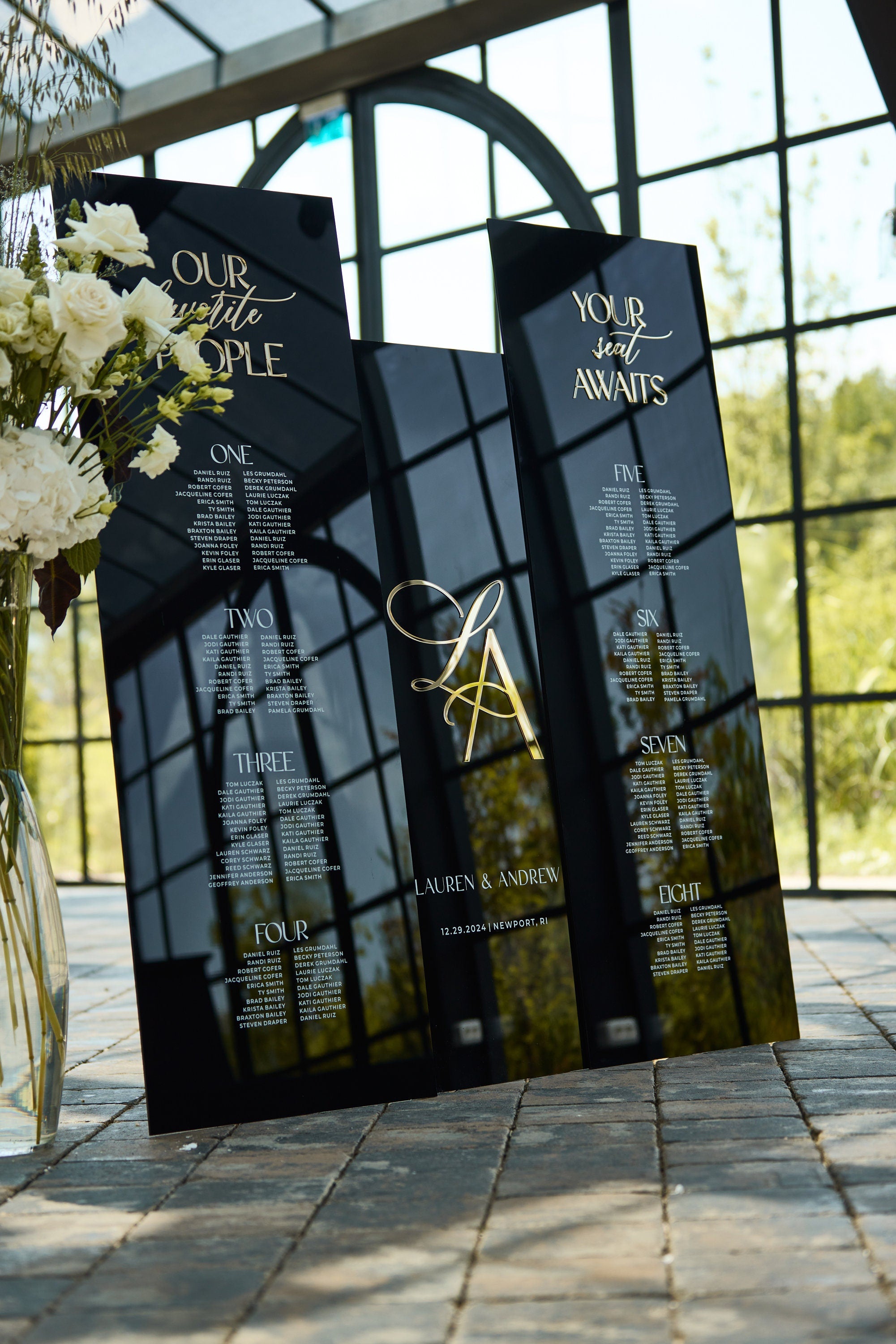Black acrylic Our Favorite People seating chart with guest names
