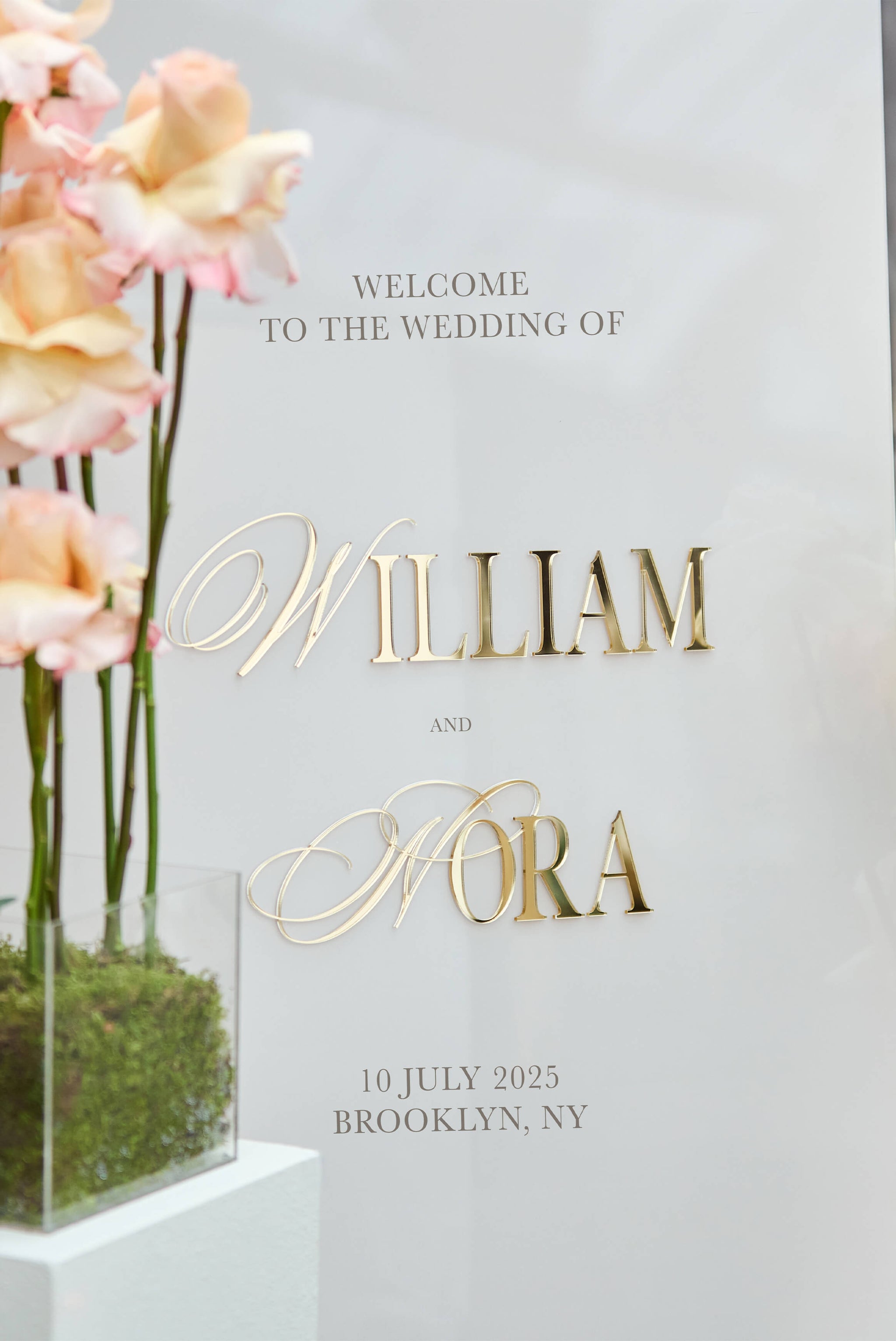 Close up of raised 3D gold mirror lettering on beige acrylic background