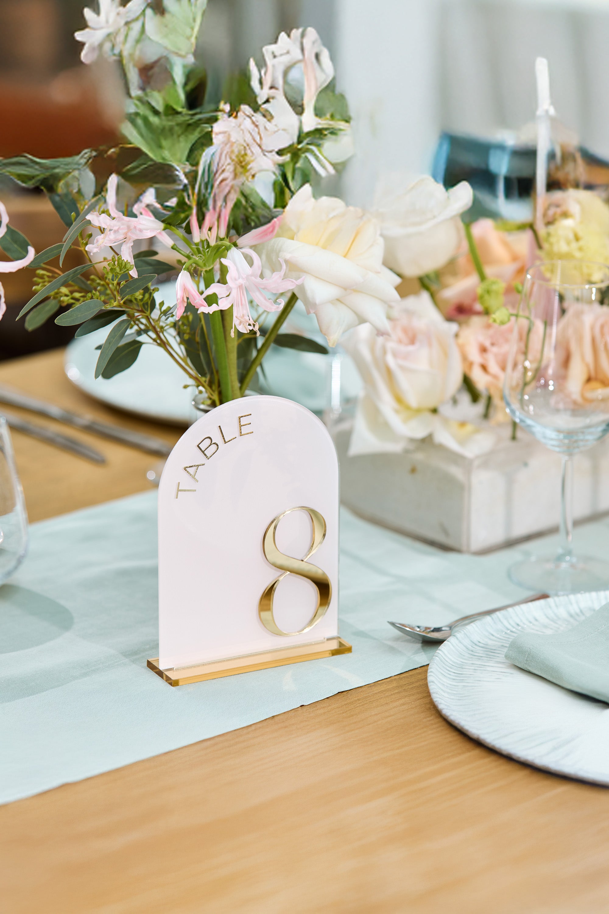 Pink acrylic wedding table numbers with 3D gold mirror digits.
