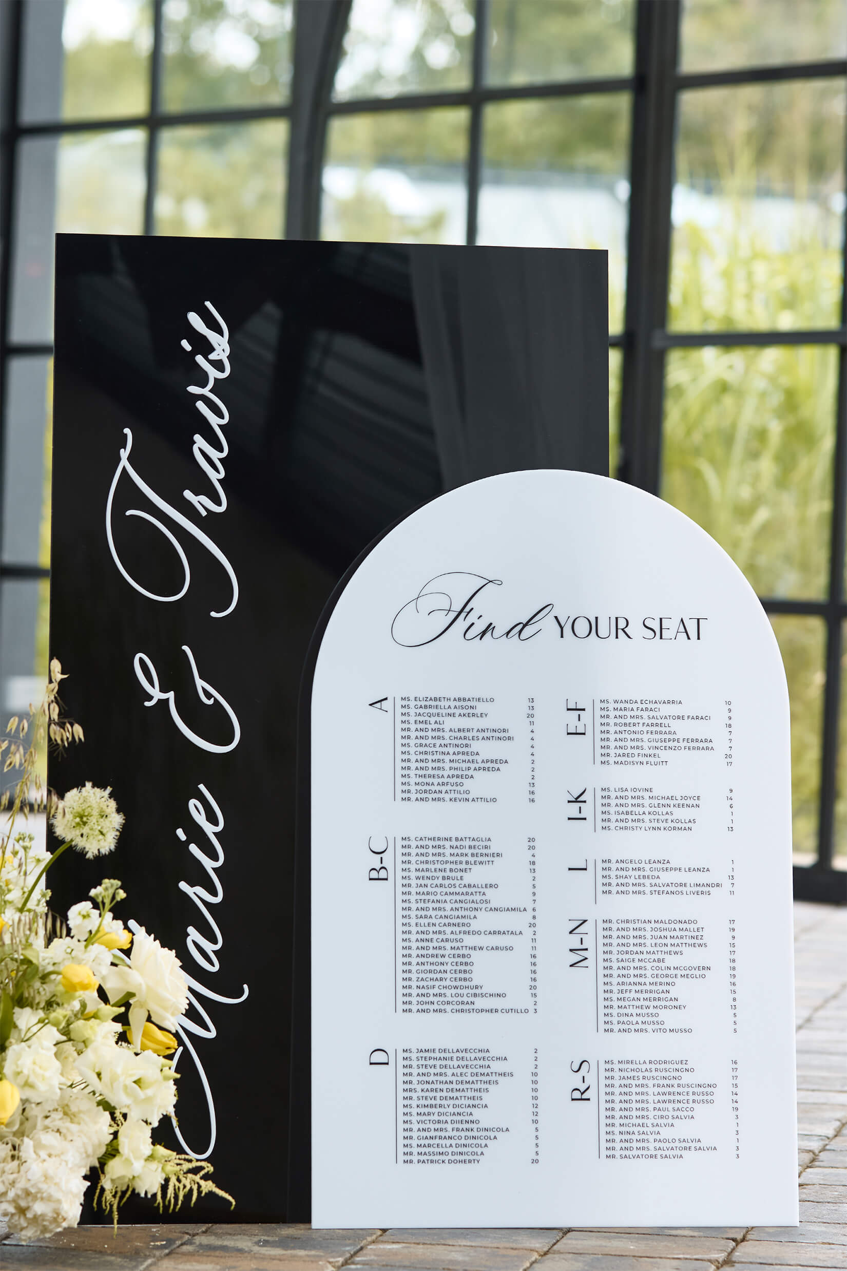 Detail shot of 3D raised acrylic lettering on black and white seating chart, showing high-contrast finish.