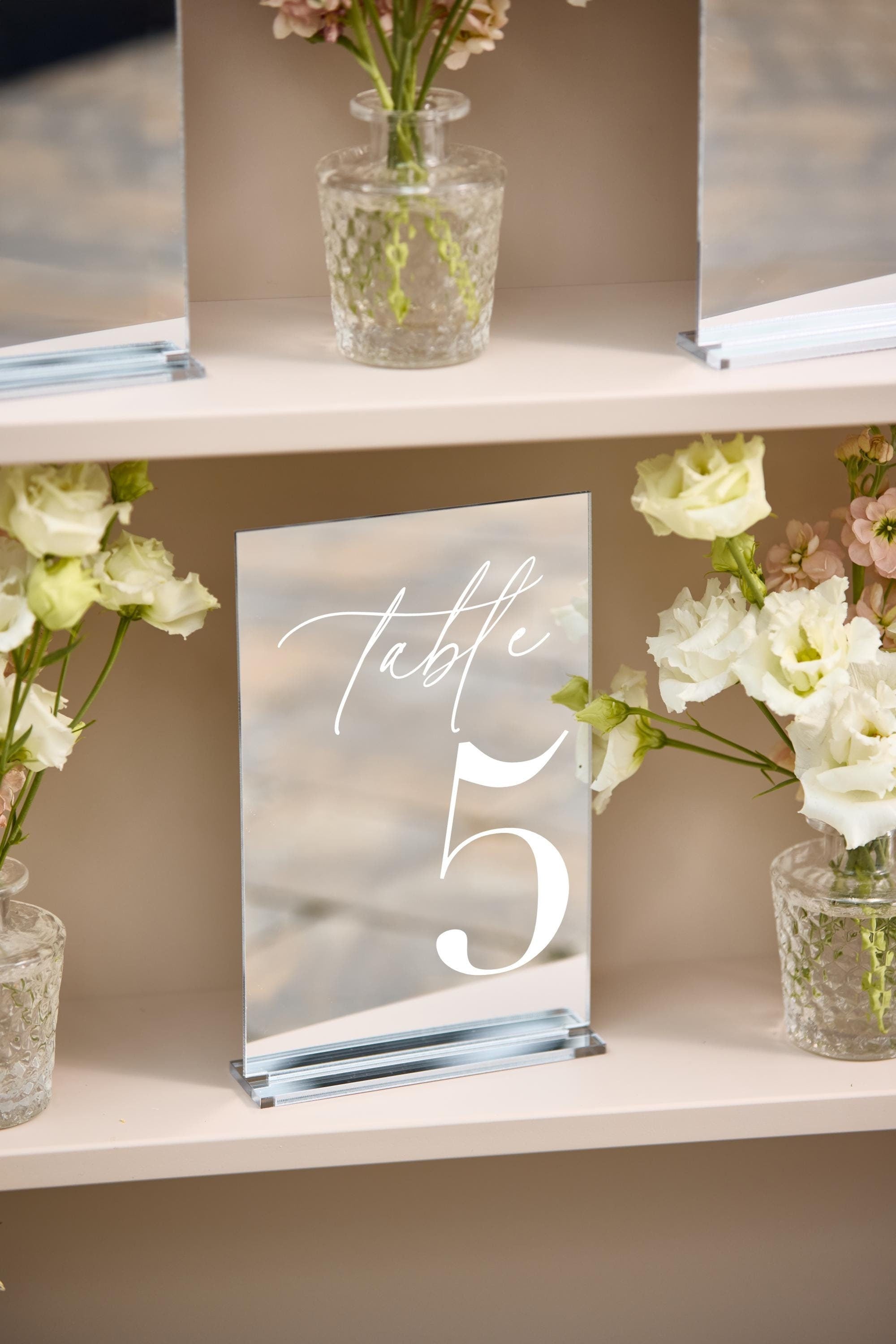 Modern silver mirror wedding table numbers with white text
