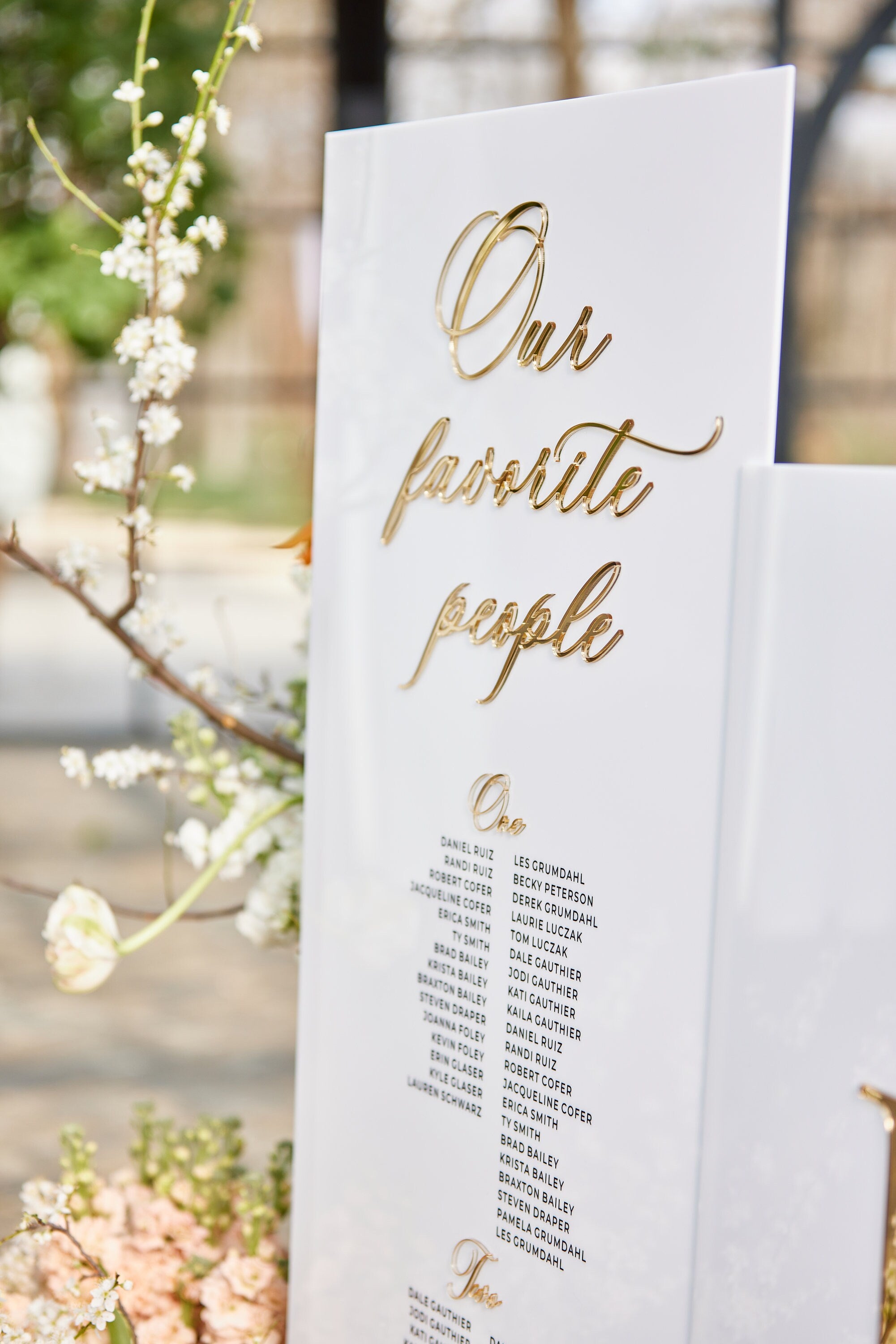 White acrylic seating chart with 3D gold mirror Our Favorite People  title 
