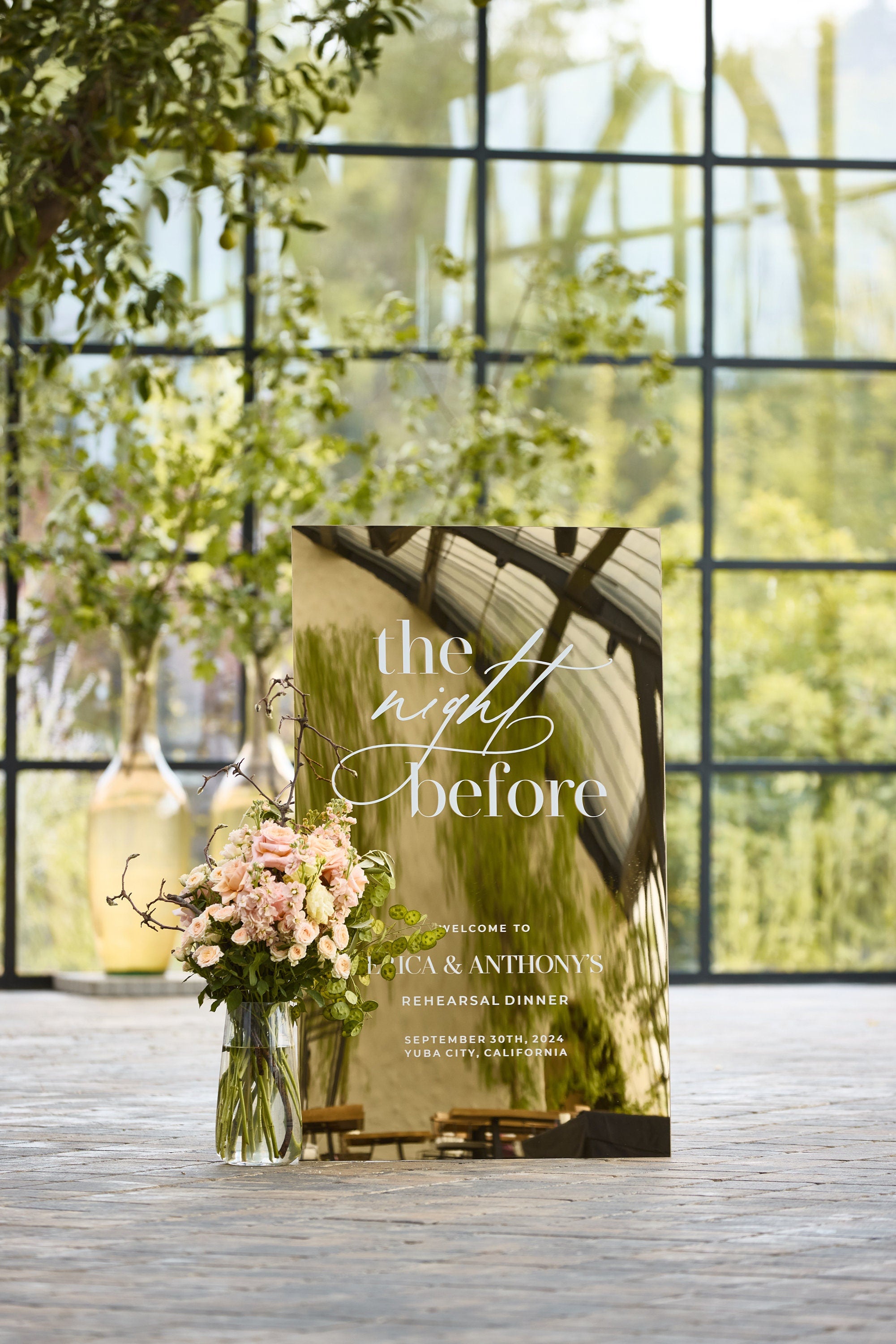 Elegant rehearsal dinner sign in gold mirror acrylic featuring The Night Before custom text
