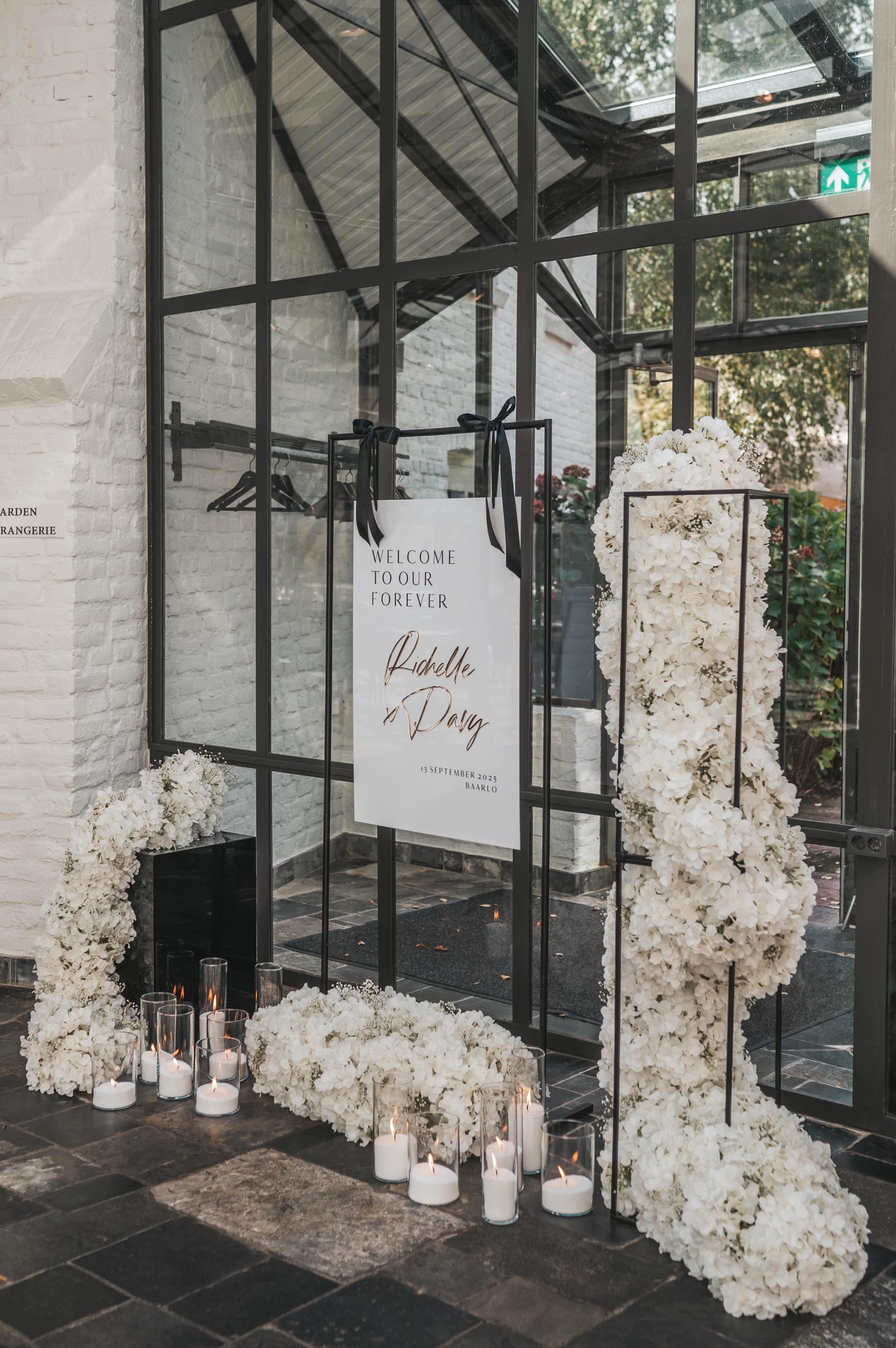 Modern wedding reception sign in white acrylic with gold mirror names
