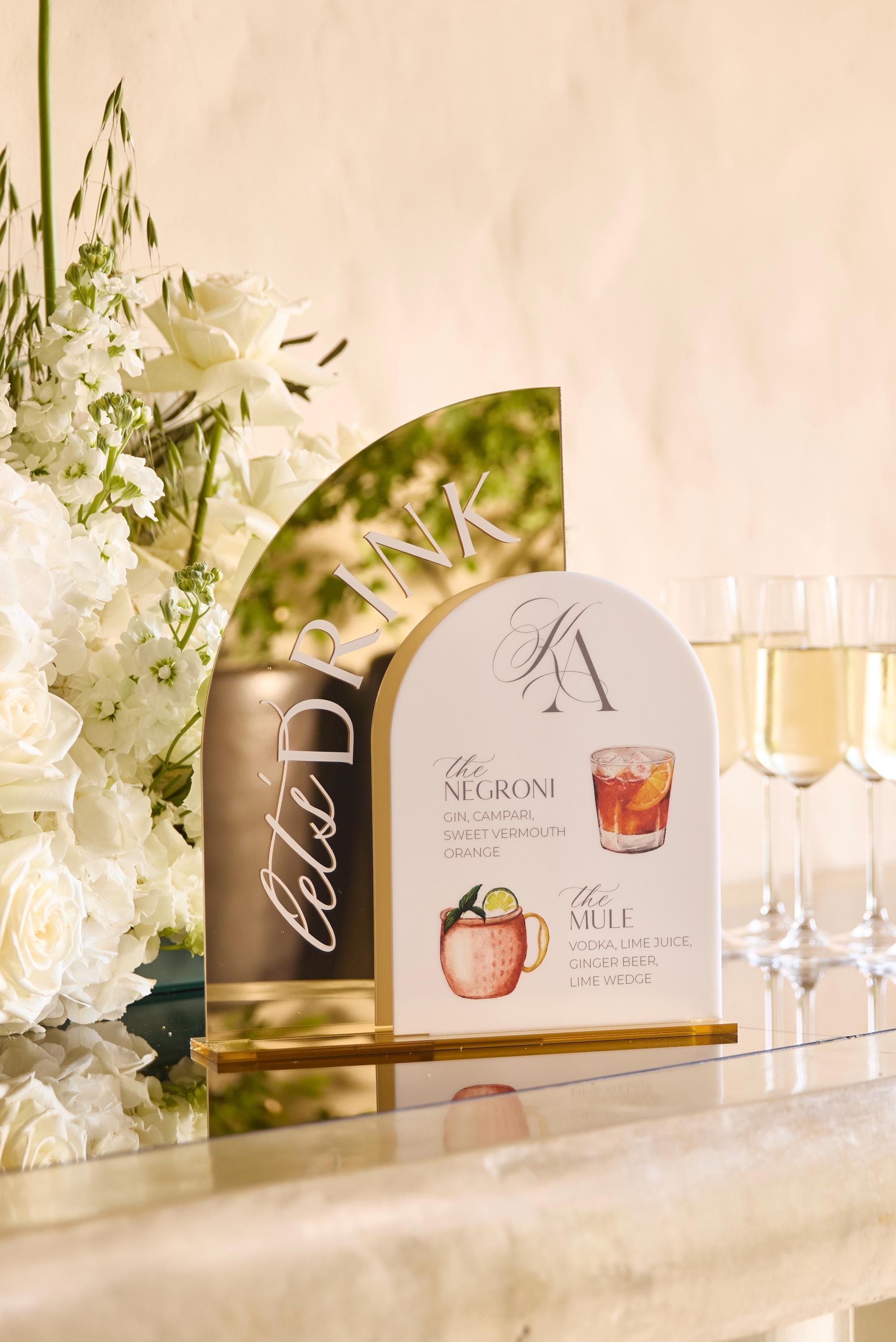 Acrylic wedding bar sign with signature cocktails.
