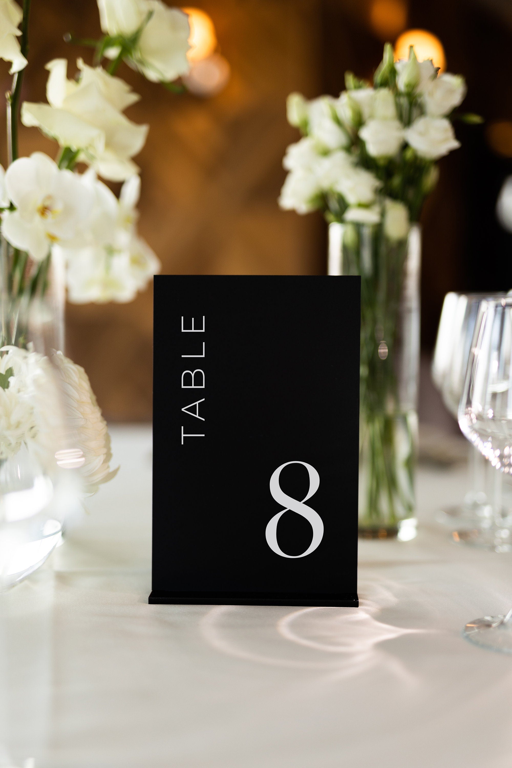 Matte black acrylic wedding table number with clean modern design