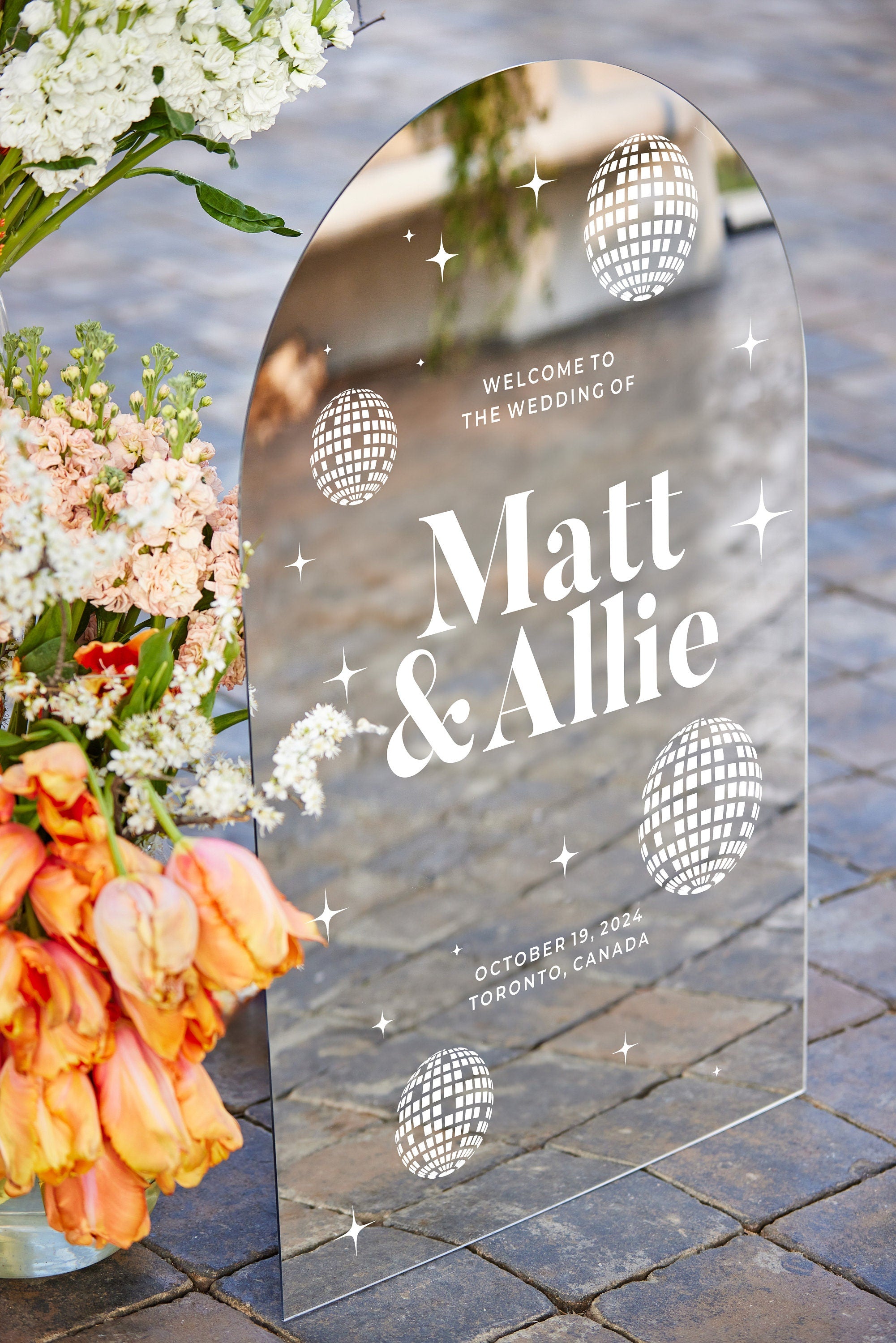 Close-up of disco ball wedding sign silver mirror acrylic with retro-inspired design
