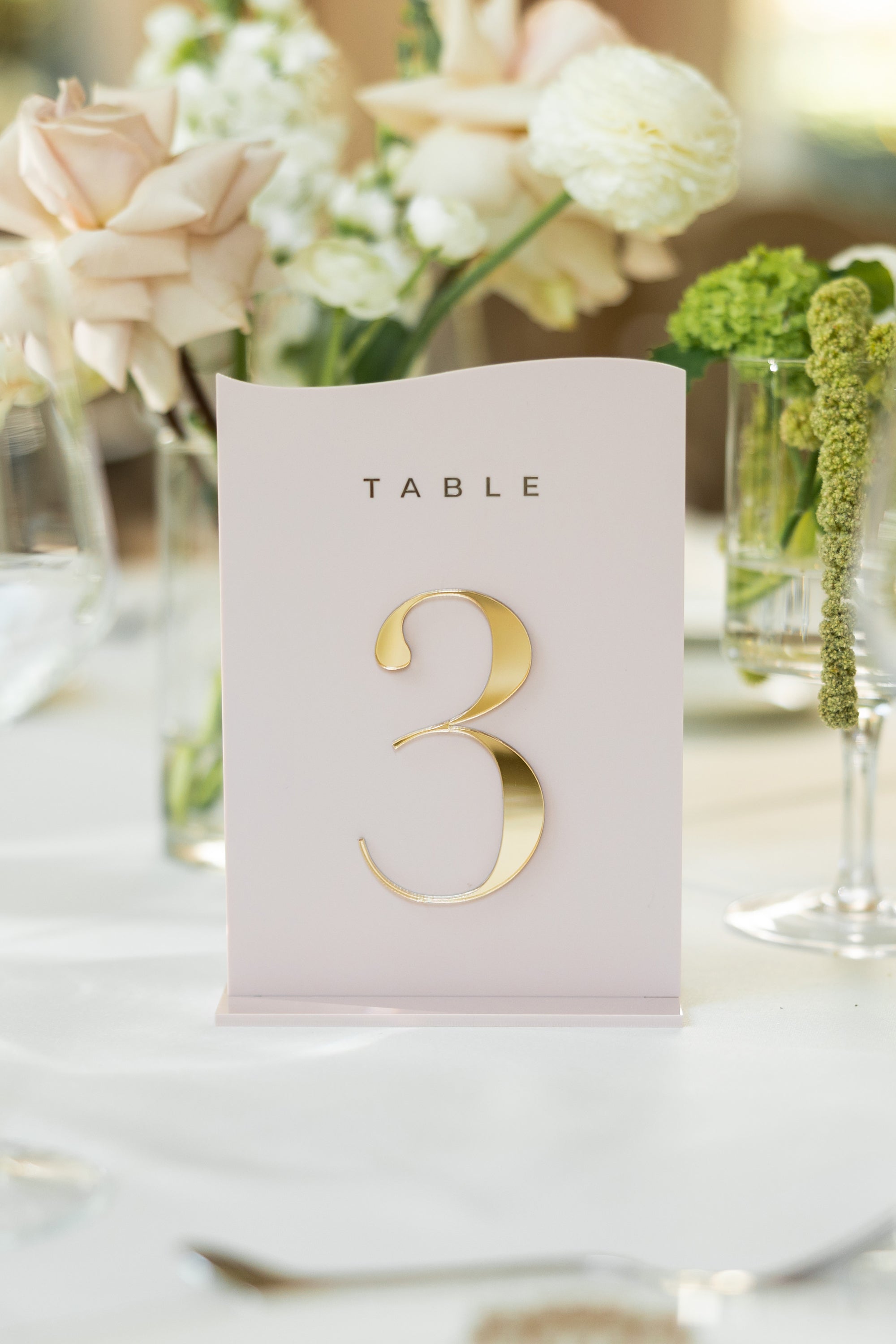  Boho chic wedding table decor with dusty pink signage.