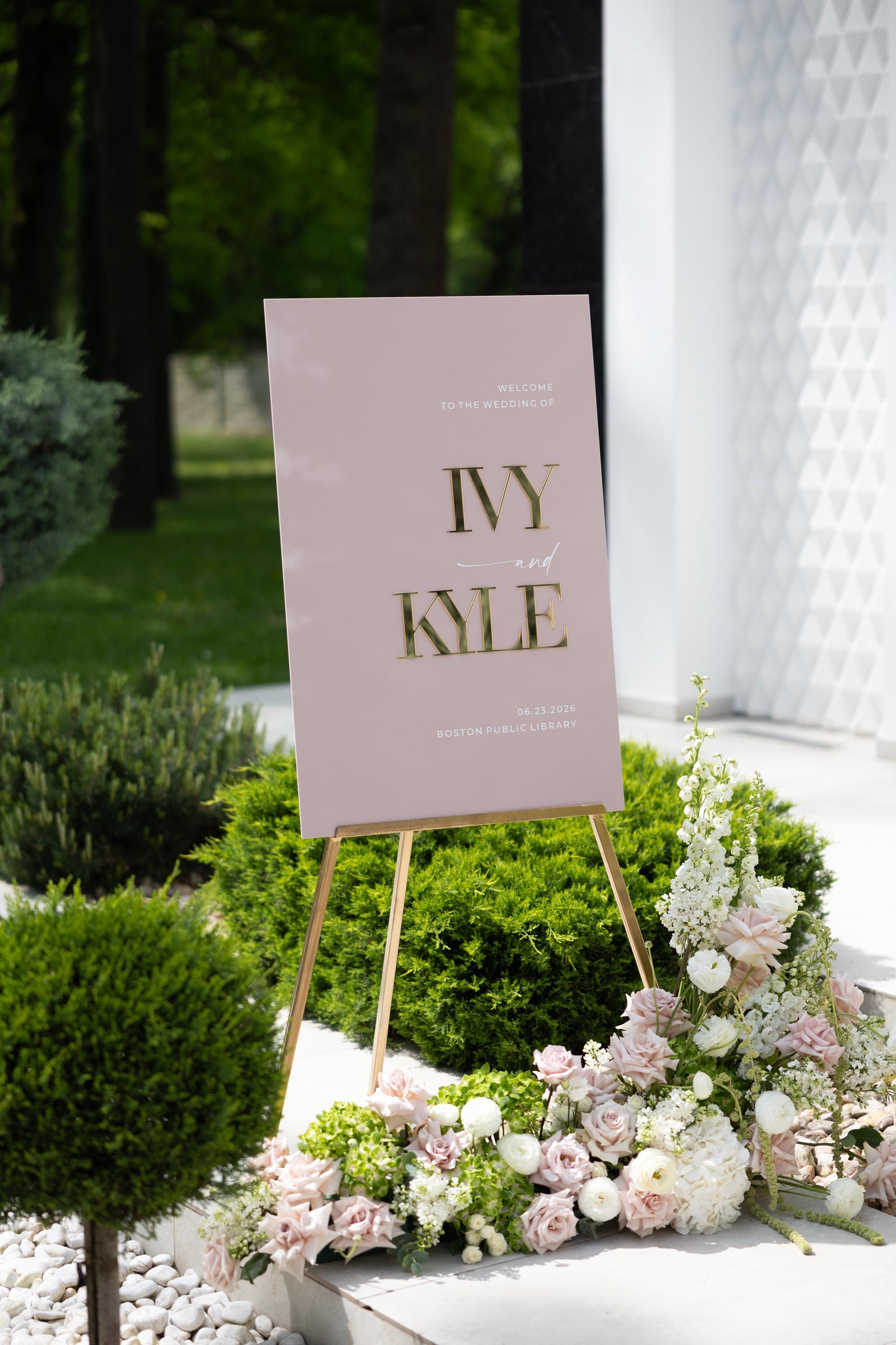 Custom wedding signage in dusty pink with high-contrast gold details