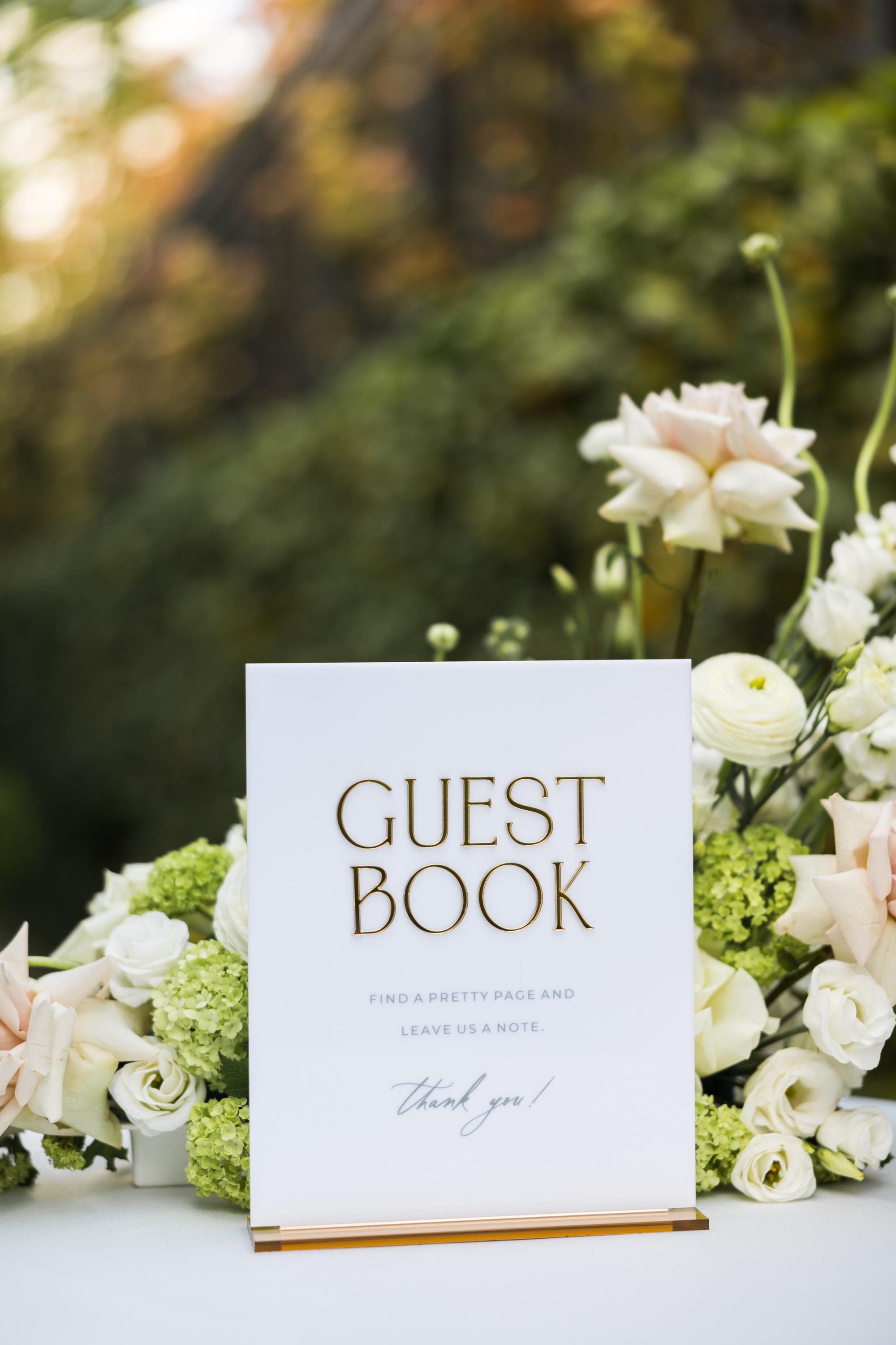 White acrylic wedding guest book table sign with gold mirror stand for reception decor
 