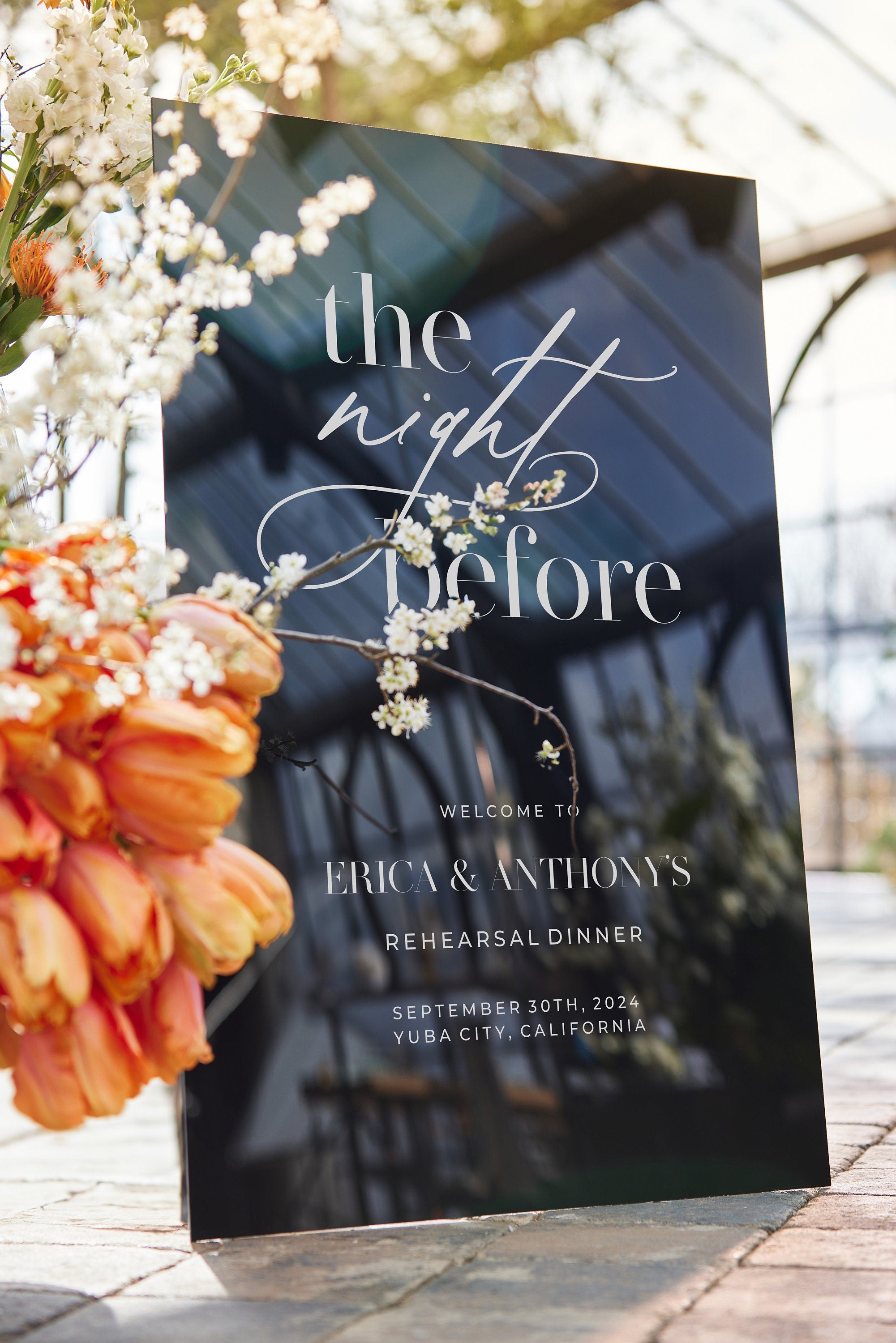 Close-up of The Night Before rehearsal sign black acrylic with white text 

