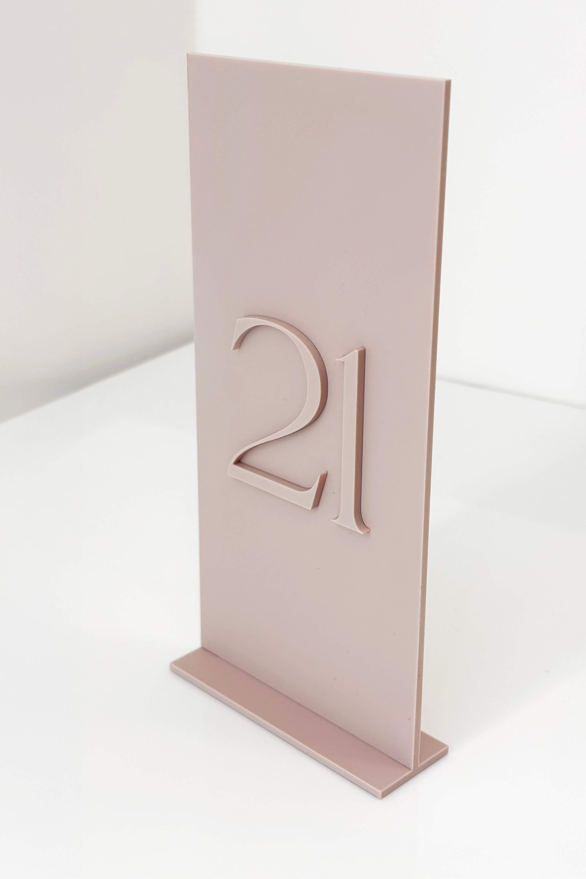 Side angle of 4x8 inch dusty pink table number showing the thickness of the acrylic stand.