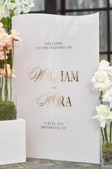 Wedding welcome sign with 3D gold mirror names on beige acrylic background
