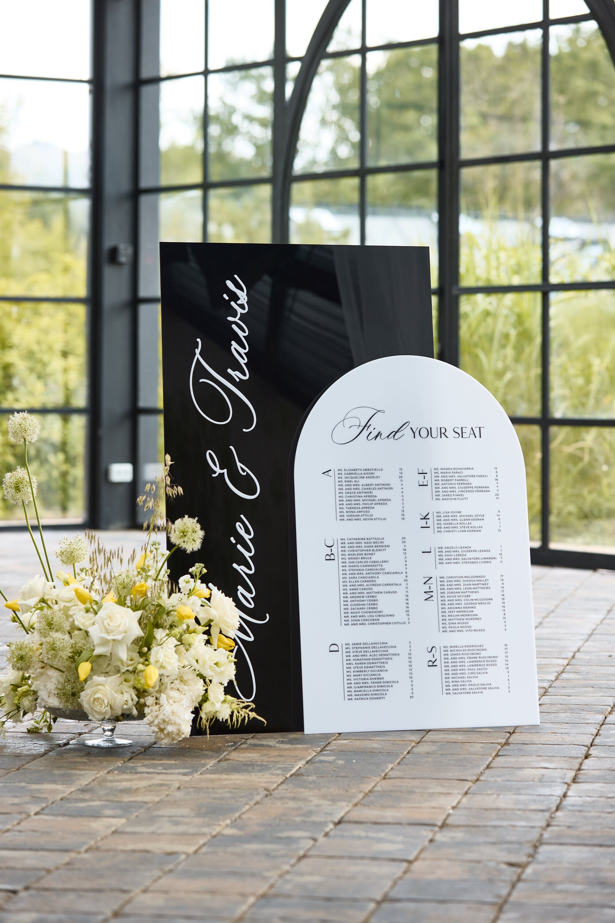 Wedding seating chart black white acrylic with alphabetical guest names 
