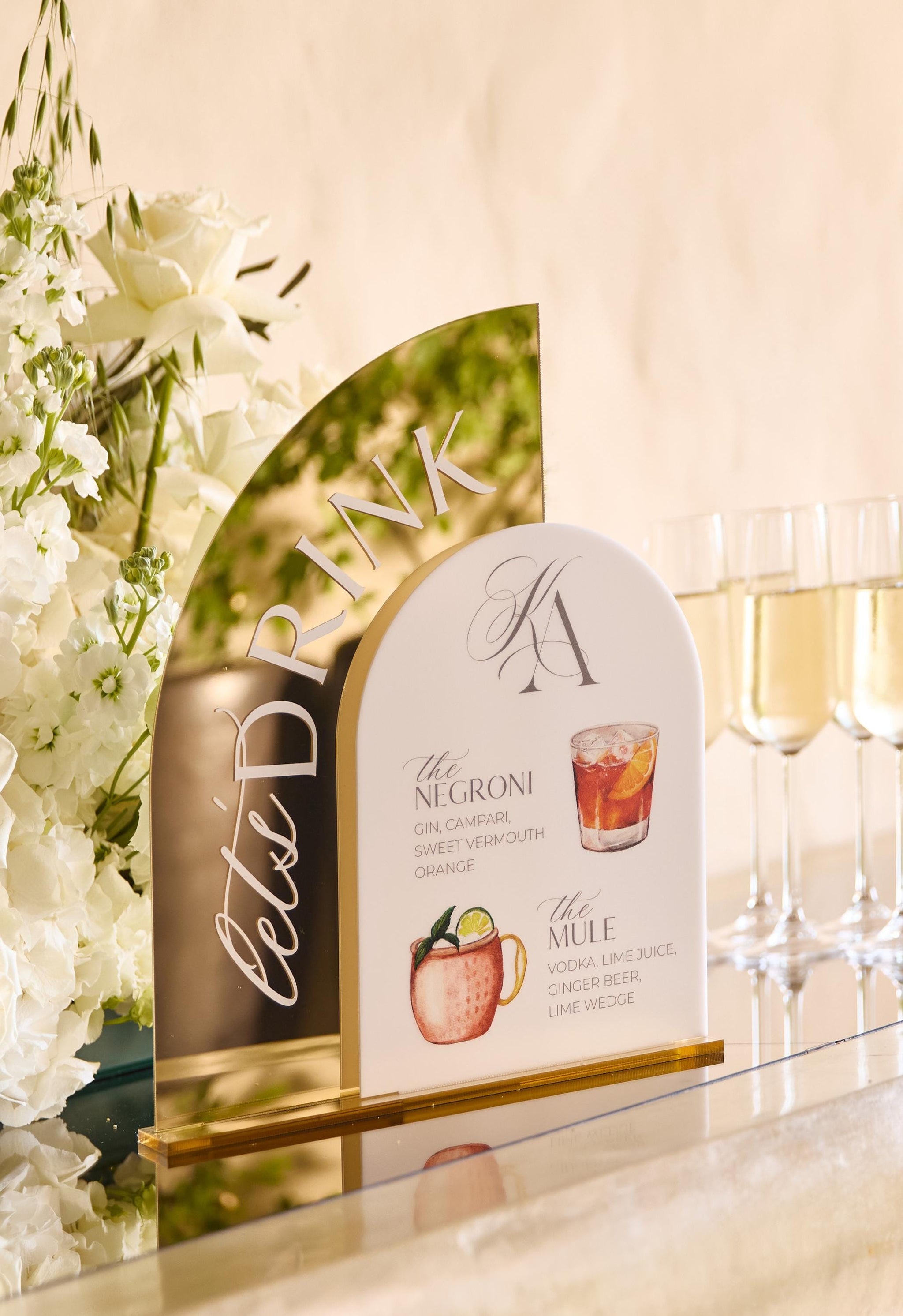 Acrylic wedding bar sign featuring custom signature drink illustrations and cocktail recipes
