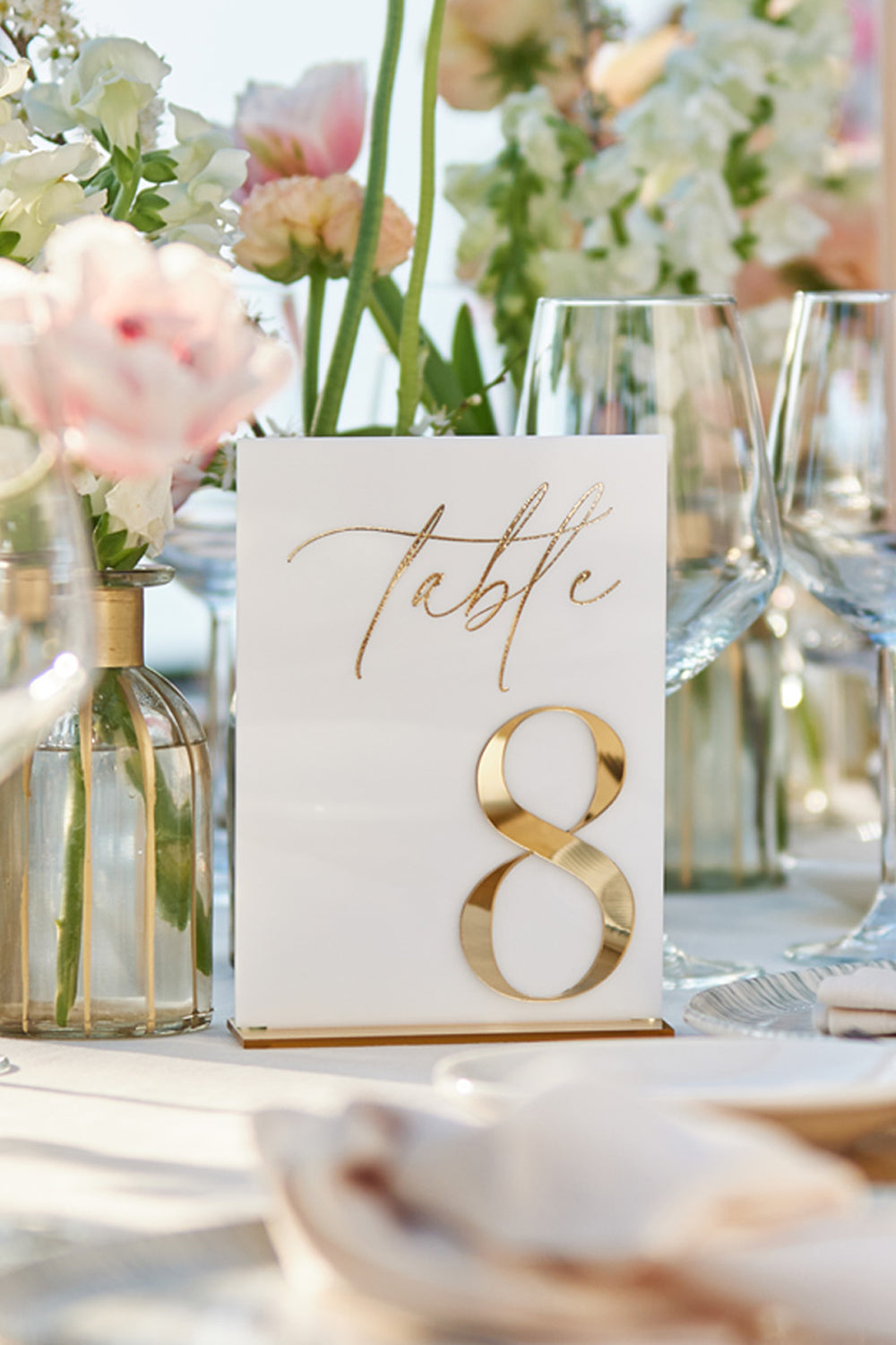 Laser cut gold mirror table number detail.