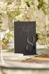 Black matte acrylic wedding table numbers with 3D raised digits.