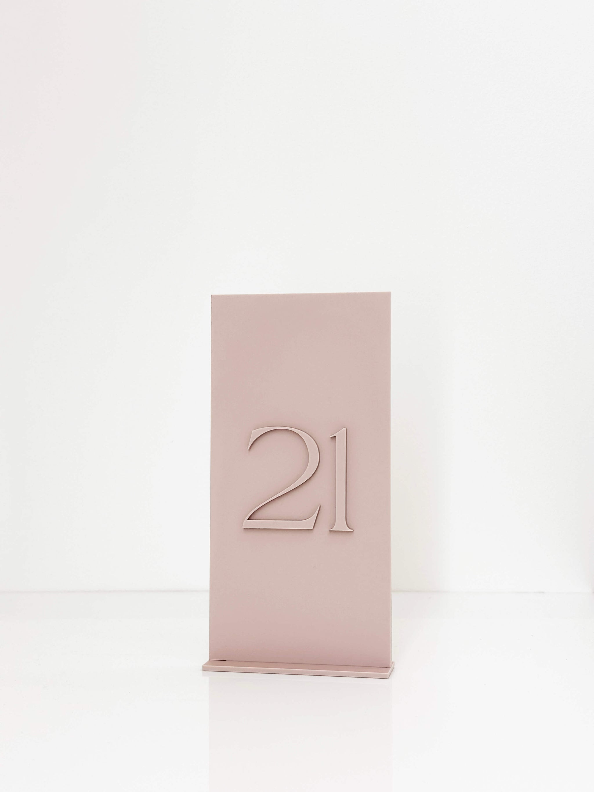 Mauve wedding centerpiece styled with a custom acrylic table number.