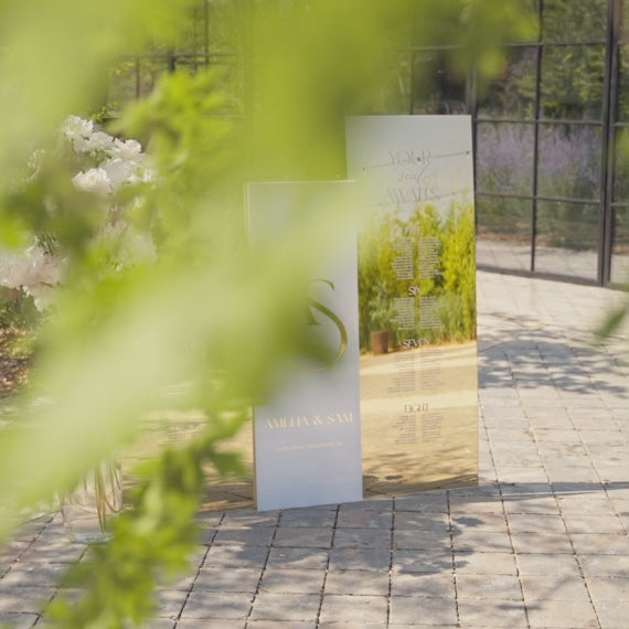 Gold mirror acrylic wedding seating chart and welcome sign bundle displayed at elegant reception