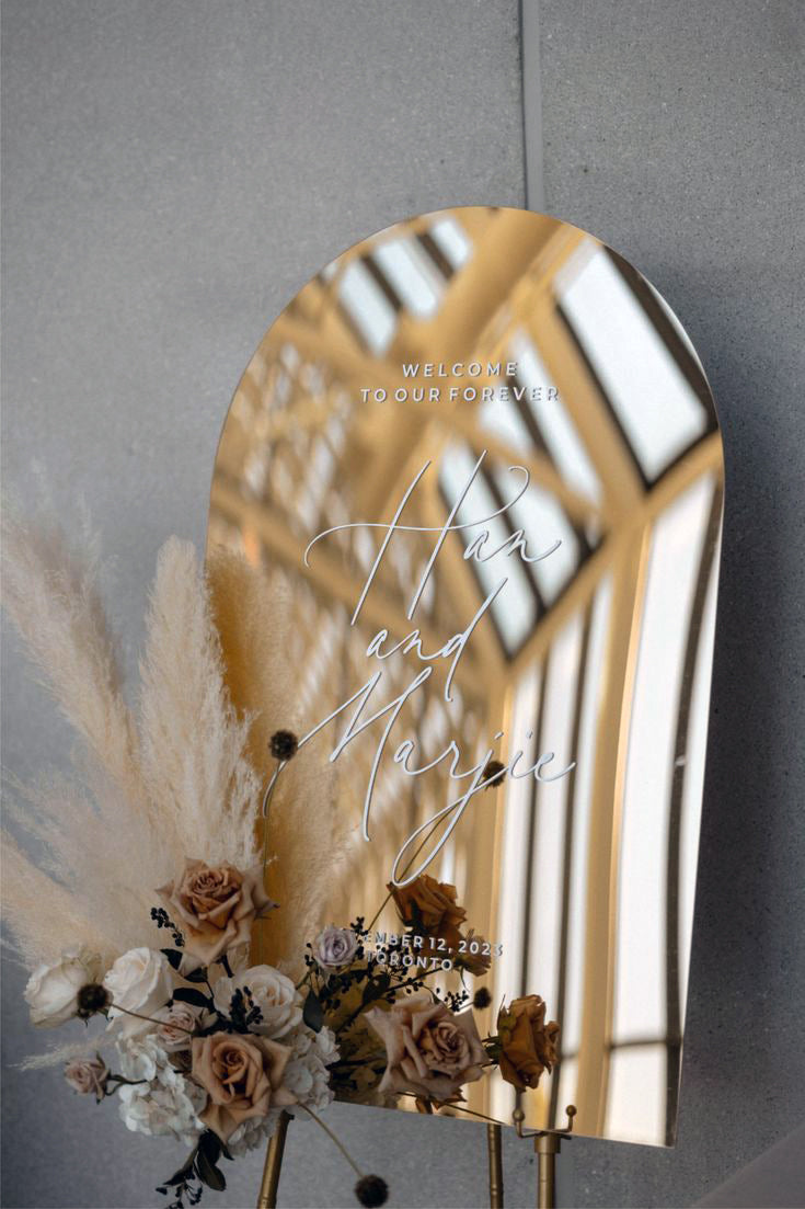 Arched Gold Mirror Wedding Welcome Sign styled with boho pampas grass and roses.