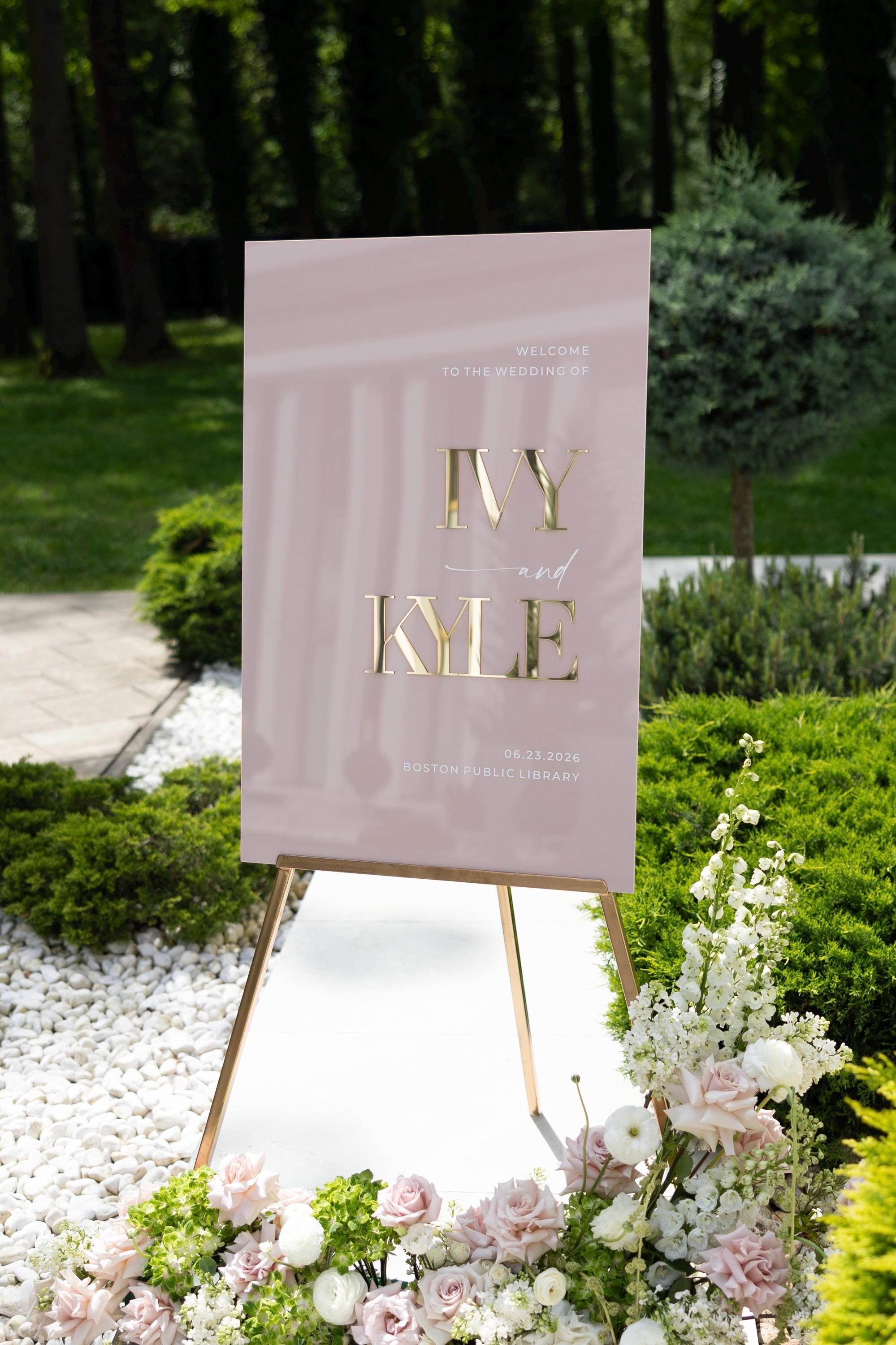 Custom wedding signage in dusty pink with high-contrast gold details