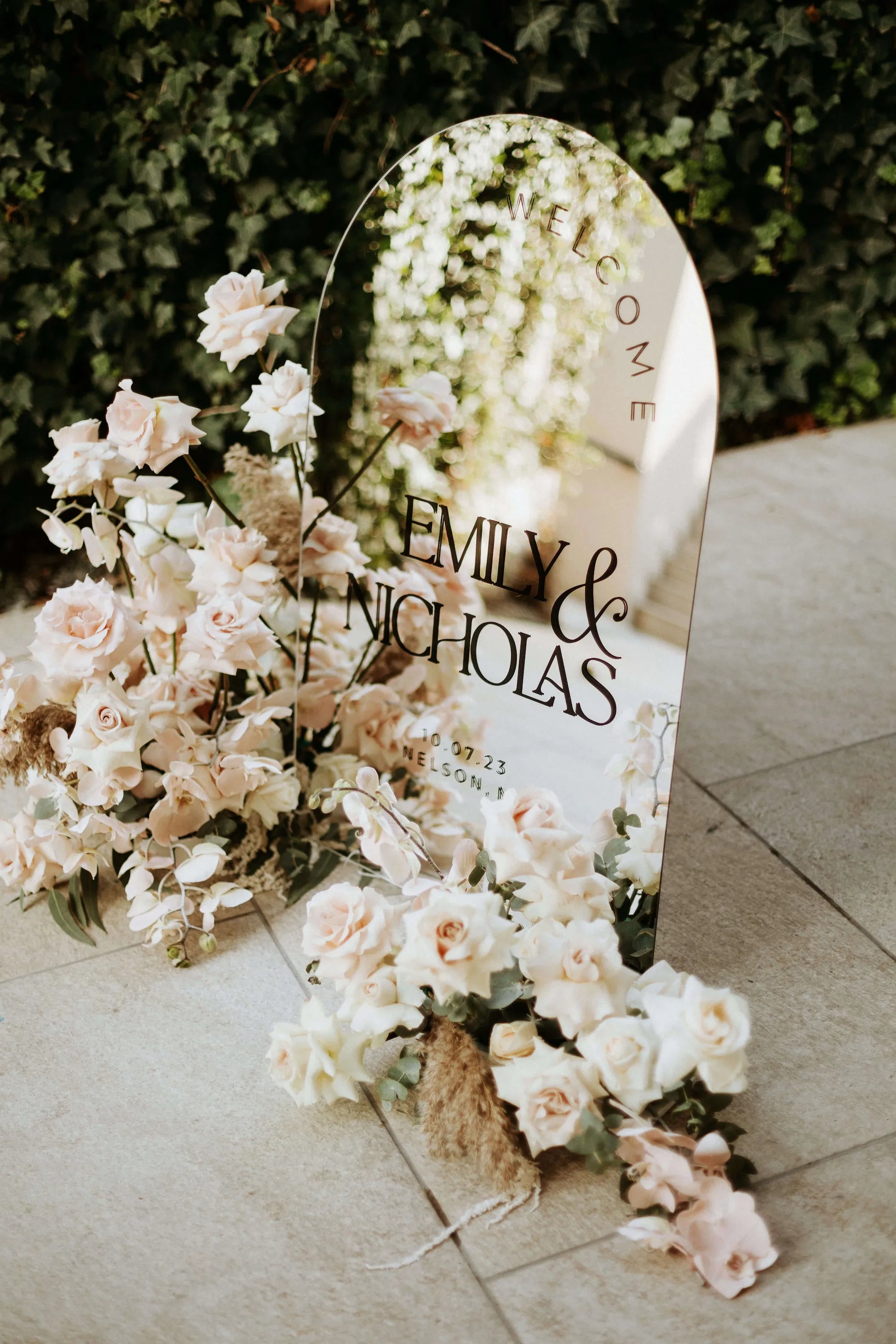 Arched silver mirror acrylic wedding welcome sign showing reflective surface and personalized lettering