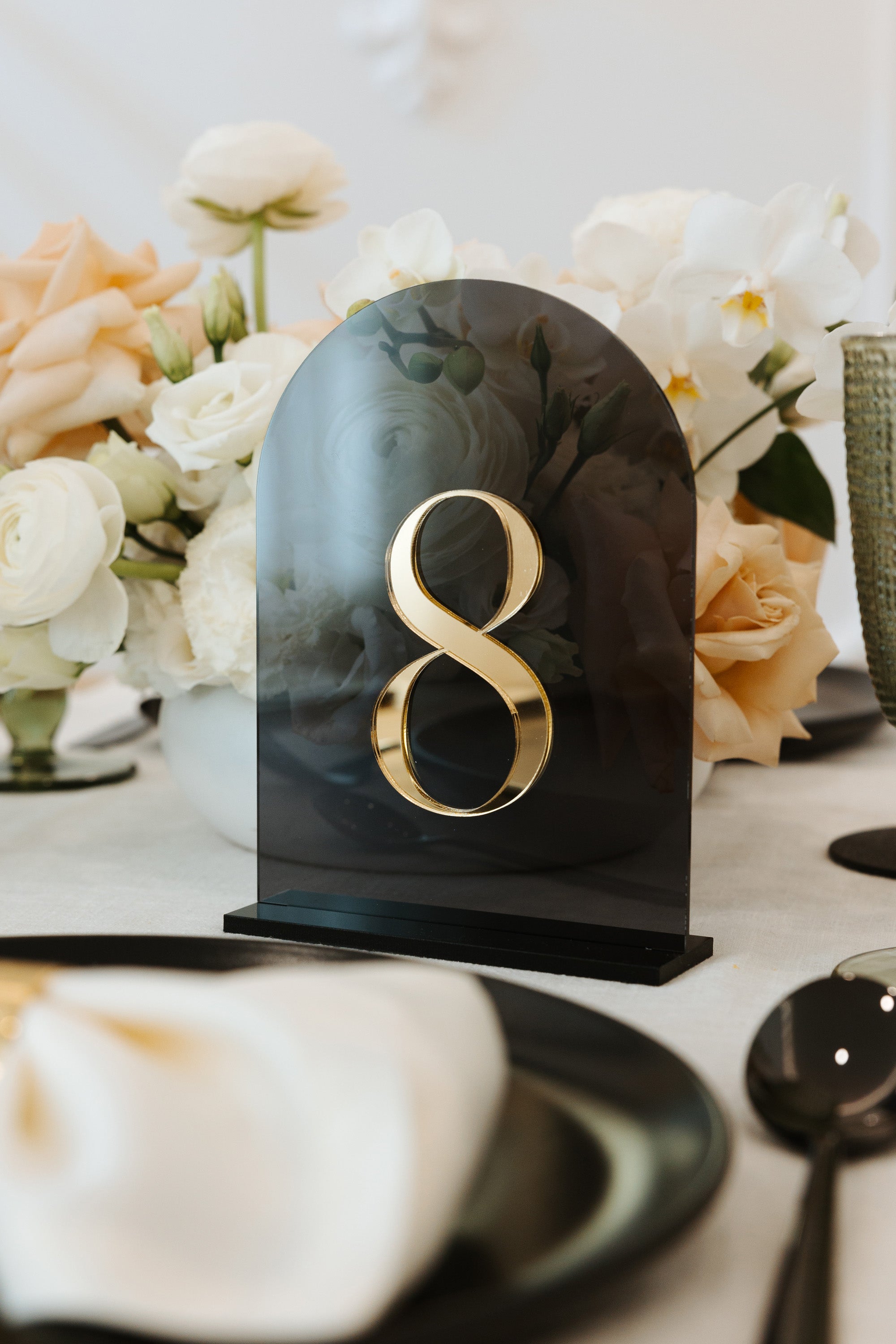 Translucent grey acrylic table number sign close up.