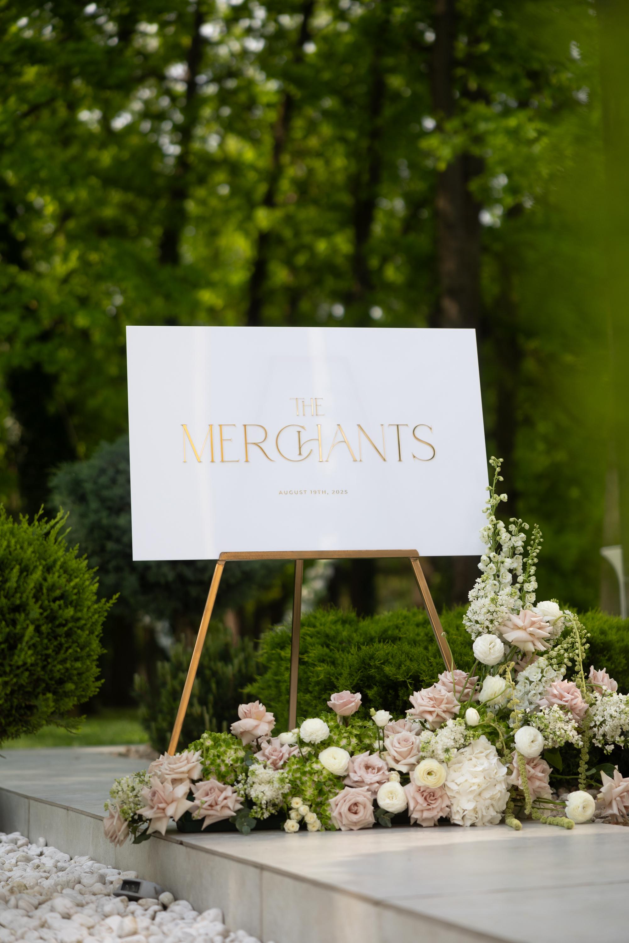 Reception decor featuring a white board with metallic gold 3D accents.